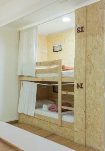 a room with two bunk beds in a wall at HOSTEL NAMOR in Ribadeo +102 photos