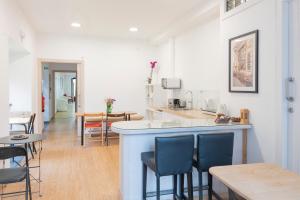 a kitchen and dining room with a bar and chairs at HOSTEL NAMOR in Ribadeo
