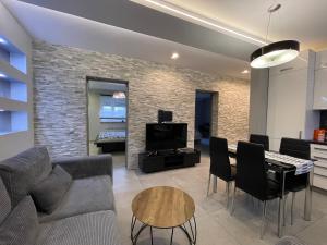 a living room with a couch and a table at Apartament Ala in Zabrze
