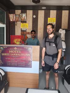 a man standing on a platform in a room at Hotel Shree Sanwaliya INN in Ayodhya +14 photos