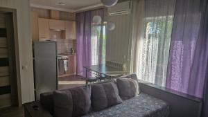 a living room with a couch and a kitchen with a table at Старе місто, центр in Lutsk
