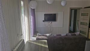 a living room with a couch and a flat screen tv at Старе місто, центр in Lutsk