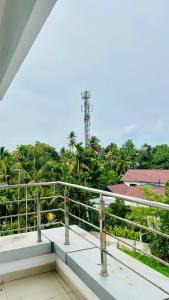 a view from the balcony of a building with trees at Palmyra Hotel and Suites in Kollam