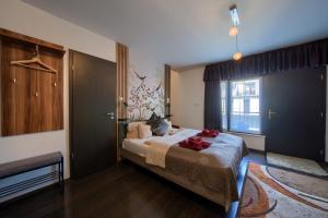 a bedroom with a bed with red towels on it at Budapest Center Residence in Budapest