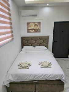a bedroom with a large bed with two pillows on it at Studio centar Lazic 1 in Šid