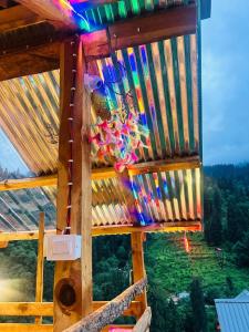 a view from the top of a wooden house with colorful lights at The WILD Canopy in Kulu