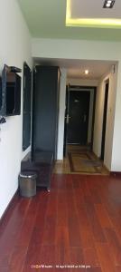 a room with a hallway with two doors and a tile floor at Hotel San Andreas Amar in Kodaikānāl +3 photos