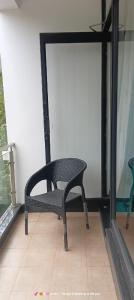 a chair sitting on a floor next to a window at Hotel San Andreas Amar in Kodaikānāl