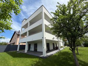 a white building with a tree in front of it at Vila Gaia in Sarajevo