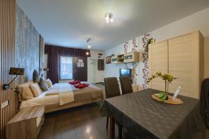 a bedroom with a bed and a table in a room at Budapest Center Residence in Budapest