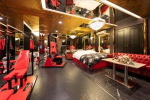 a hotel room with a bed and red furniture at ホテル ダブルイン茨木 in Ibaraki