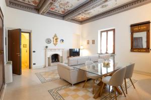 a living room with a table and a couch at TUSCANFLAT Castle in Scrofiano