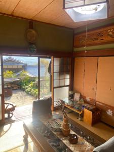 a living room with a table and a large window at Inn Omishima in Imabari +45 photos