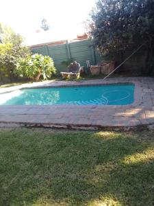 a swimming pool in the backyard of a house at Star Contractors Accodation with self catering in Mahikeng