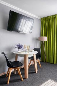a table and two chairs with wine glasses on it at APART-HOTEl 95 in Almaty