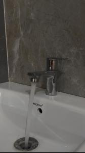 a bathroom sink with a faucet on top of it at Nasa in Panchanai