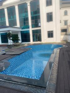 a large swimming pool in front of a building at Army Hotel in Yen