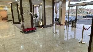 a lobby with a luggage cart in a building at دولف للشقق الفندقية حي المصيف in Hail +37 photos