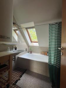 a bathroom with a tub and a sink and a window at Villa Pdorf in Perchtoldsdorf +67 photos