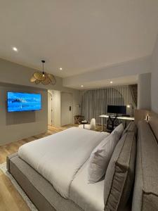 a large bedroom with a large bed and a flat screen tv at Punnpreeda Beach Resort - SHA Plus Certified in Bangrak Beach