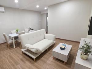 a living room with a couch and a table at Juichi Homestay in Kluang