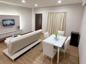a living room with a large couch and a table at Juichi Homestay in Kluang