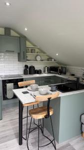 a kitchen with a table with bowls on it at The Loft in Gwys Station