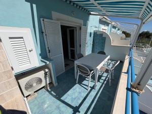 a table and chairs on the balcony of a house at Magi - Appartamenti Maga Circe in Ponza