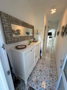 a bathroom with a sink and a tile floor at Magi - Appartamenti Maga Circe in Ponza +77 photos