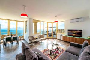 a living room with a couch and a table at ERAL Apart-Hotel & Penthouse in Sarandë