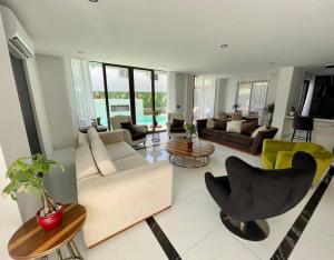 a living room with couches and chairs and tables at Villa Sunset in Marmaris