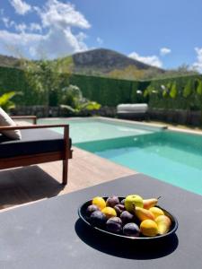 a bowl of fruit on a table next to a pool at Villa Sunset in Marmaris