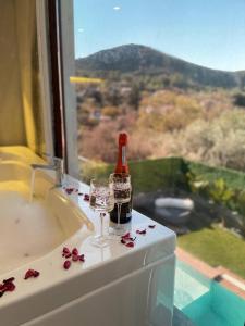 a bottle and glasses on a counter with a window at Villa Sunset in Marmaris