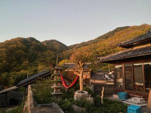 a playground with a slide in front of a house at Inn Omishima in Imabari