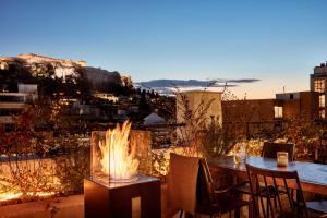 a patio with a table and a fire pit at The Zillers Boutique Hotel in Athens