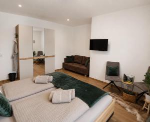 a living room with two beds and a couch at Boutique Appartements Kumming inkl Nationalparkcard in Rauris