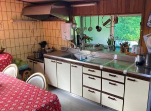 a kitchen with a sink and a counter top at Inn Omishima in Imabari