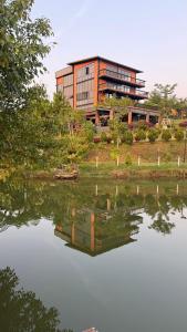 a building next to a body of water at Lang Omm in Tang Klang