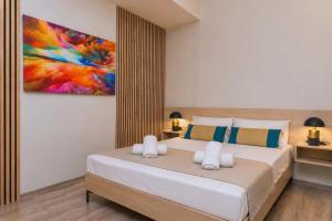 a bedroom with a bed and a painting on the wall at Sole e Mare B2 Beachfront Sea View Apartment in Koutsourás