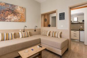 a living room with a couch and a table at Sole e Mare B2 Beachfront Sea View Apartment in Koutsourás