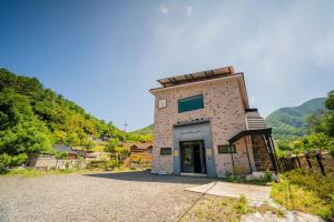 a building on the side of a hill at Okcheon Somakdaegi Pension in Okcheon