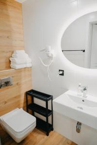 a bathroom with a sink and a toilet and a mirror at Villa Viola in Mielno +90 photos