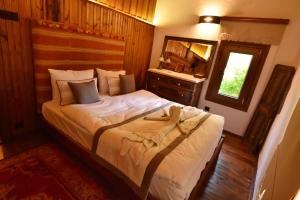 a bedroom with a bed and a sink in it at Villa Fümehan Tarihi Rum Taş Ev Since 1820 in Kayakoy +99 photos