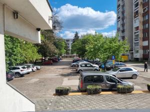 a parking lot with cars parked in it at Apartman Milica 1 in Doboj