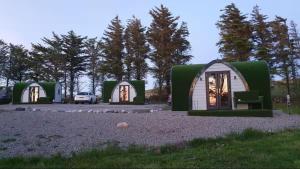 a group of three green and white dom homes at Kelp Drift, Coastal Pod, near Oldshoremore Beach in Rhiconich +21 photos