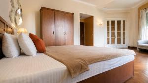 a large bedroom with a large bed and a cabinet at Cairo Dream Boutique Hotel in Cairo