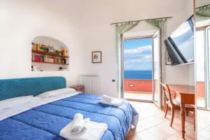 a bedroom with a bed and a view of the ocean at Il Sogno Costa d'Amalfi in Conca dei Marini