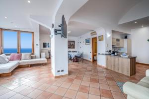 a kitchen and living room with a view of the ocean at Il Sogno Costa d'Amalfi in Conca dei Marini