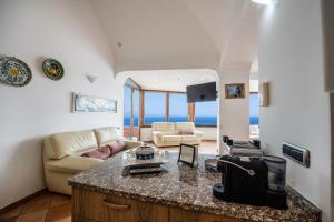 a kitchen and living room with a view of the ocean at Il Sogno Costa d'Amalfi in Conca dei Marini
