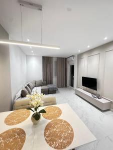 a living room with a couch and a table at Joel Family Apartment's Golem Center in Golem